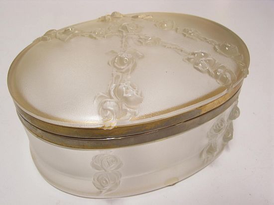 Lot 055. AN OVAL GLASS BOX with hinged lid; 'Roses en Relief' signed Lalique, France. <br>Est $350-450