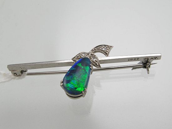 Lot 206. A BLACK OPAL AND DIAMOND BAR BROOCH. <br>Est $500-600