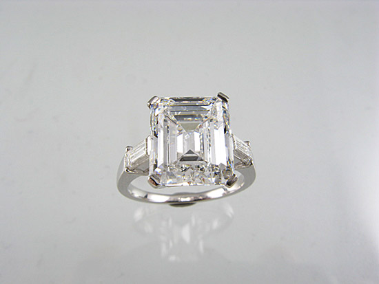 Lot 229. AN EMERALD CUT DIAMOND RING, very high grade diamond claw-set in platinum. Weight 5.34ct.<br>Est �$175000-200000