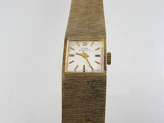 Lot 271. A LADY'S GOLD BRACELET WATCH, dial, case and movement by Girard-Perregaux. <br>Est $1200-1400